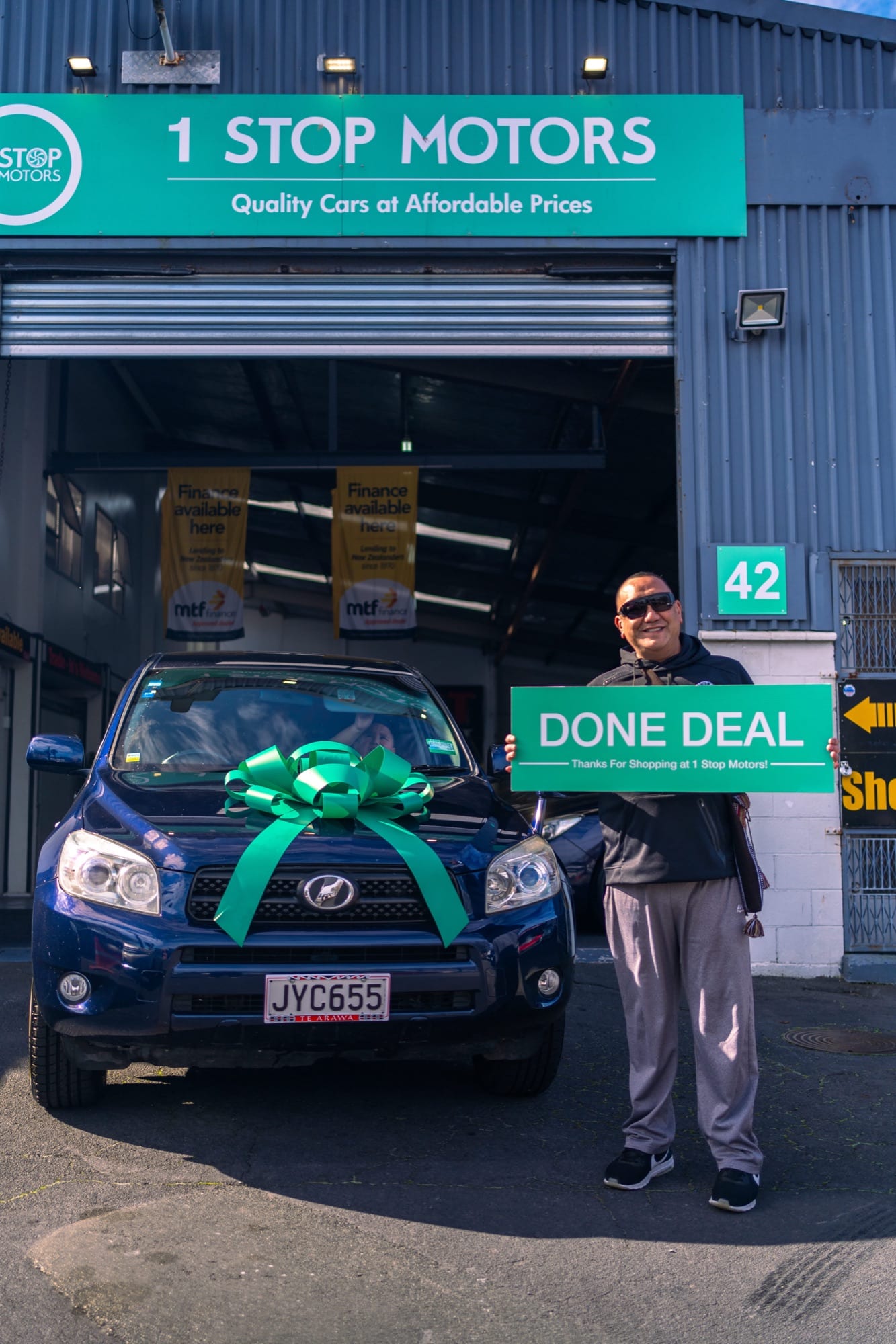 A customer handover at 1 Stop Motors