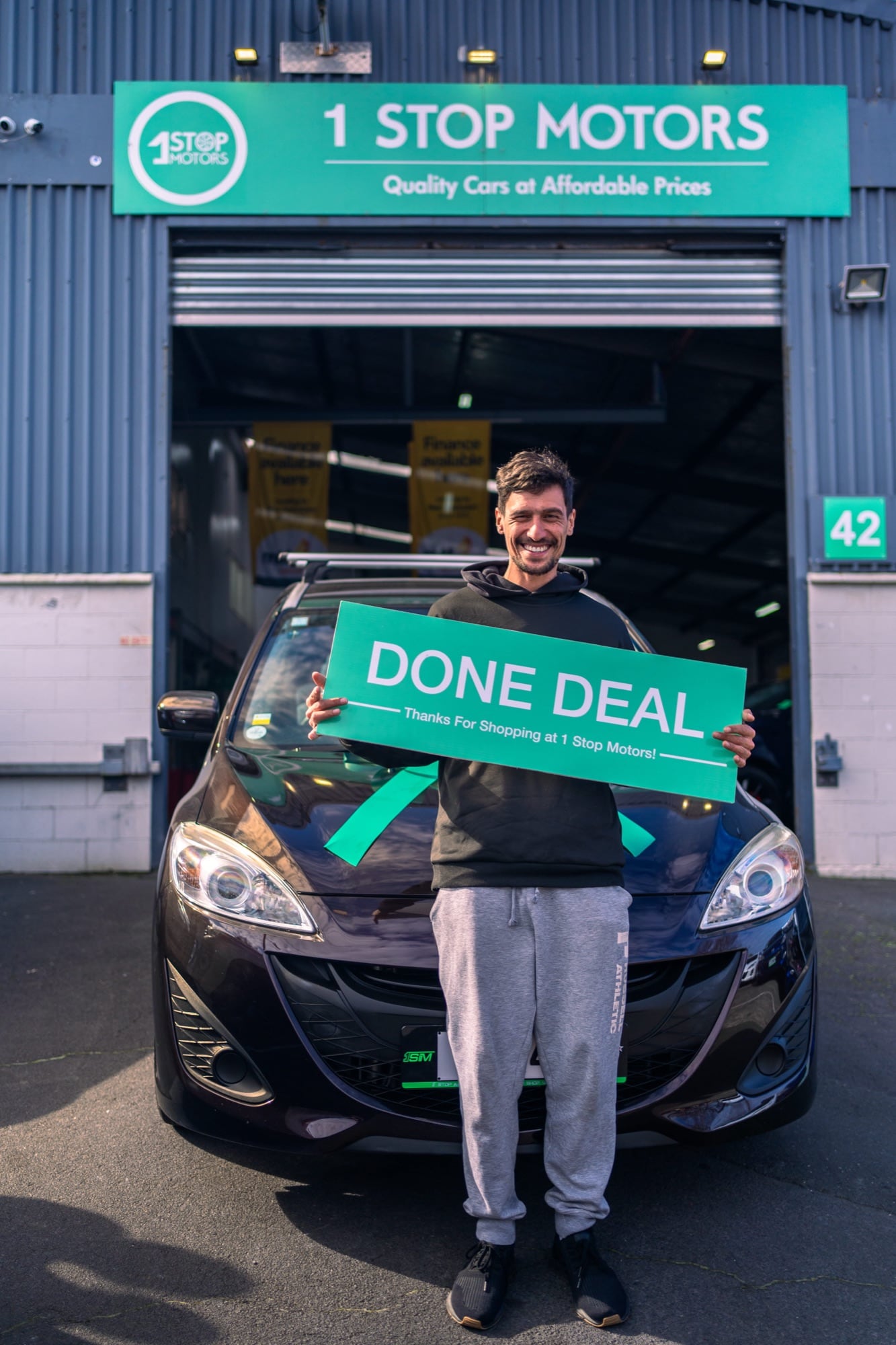 A happy customer collecting their car at 1 Stop Motors