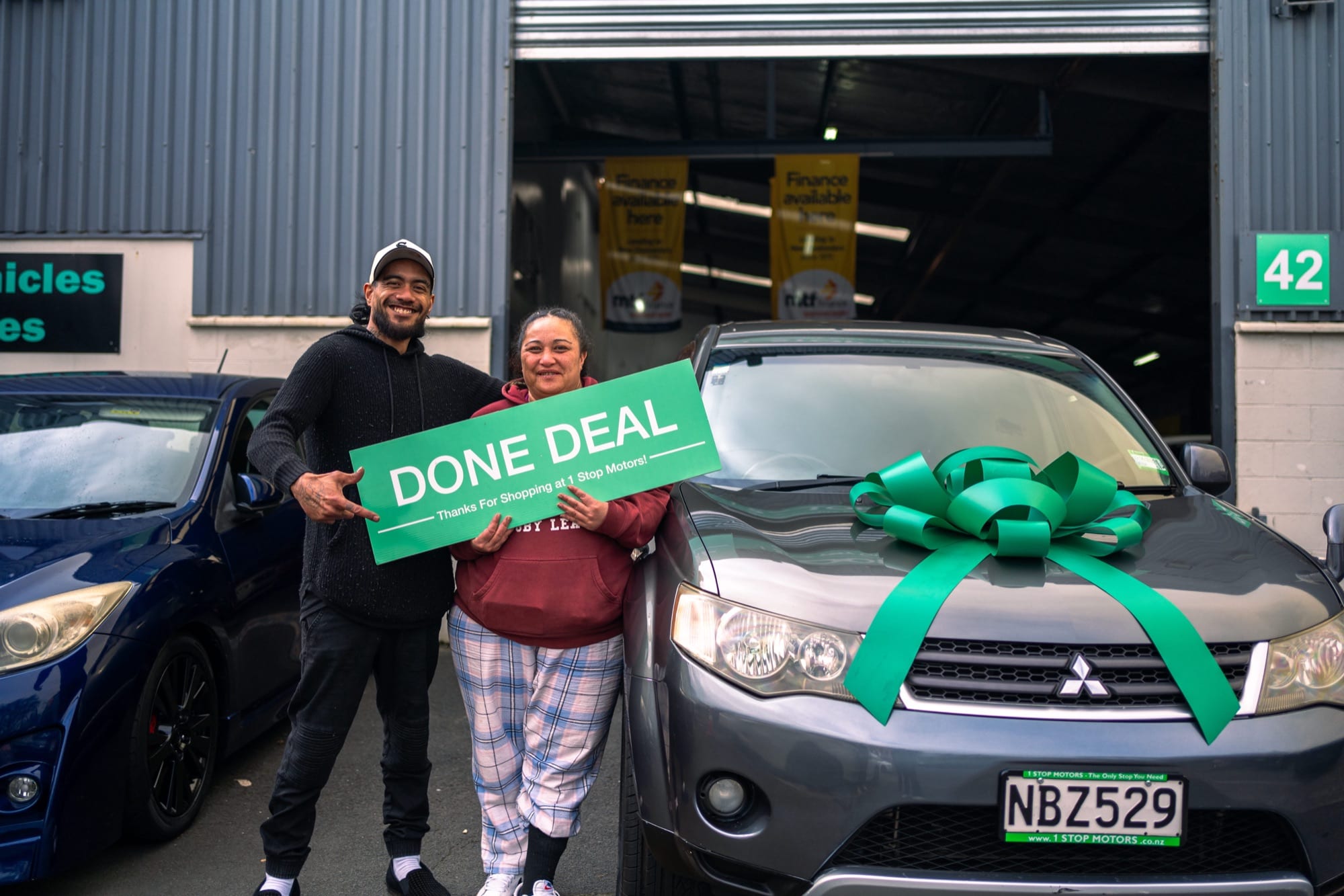 A customer handover at 1 Stop Motors